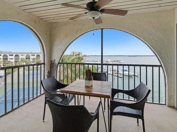 Outdoor dining - Waterfront 2BR condo with pool, marina access & full kitchen. (Marco Island)