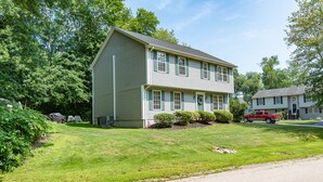 A two-story house with a front porch, a driveway, and a lawn. - Relax by the sea! 4 bedroom retreat in Bonnet Shores. Central Air sleeps 8A & 2C (Narragansett)