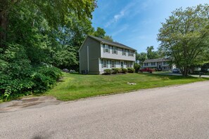 A two-story house with a front lawn and a driveway. - Relax by the sea! 4 bedroom retreat in Bonnet Shores. Central Air sleeps 8A & 2C (Narragansett)