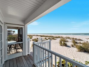 A wooden deck with a white railing overlooking a beach with sand dunes and a clear blue sky. - Beautiful view from this Palm Island Villa with All Resort Amenities, B1313A+ (Cape Haze)