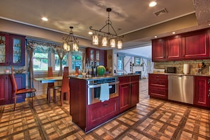Enjoy cooking in this well-equipped kitchen with a central island, stainless steel oven, and dishwasher.