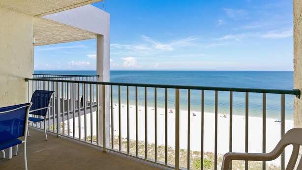 Ein Balkon mit Blick auf Strand und Meer.