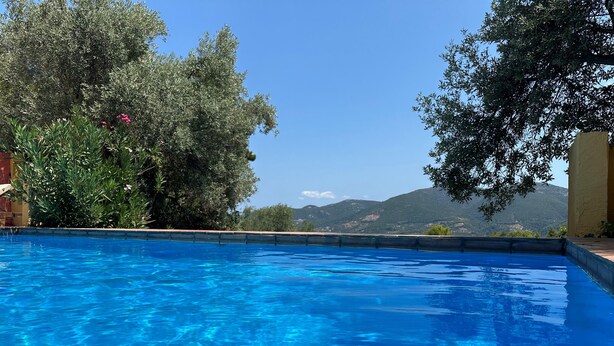 A clear blue swimming pool with a view of mountains and trees in the background. - Villa Pegasus Private pool villa ideal for a romantic get-away (Skopelos)