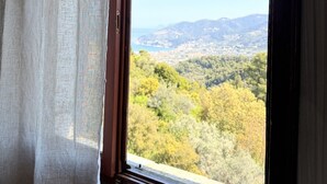 A room with a large window, a hanging light fixture, and a view of a mountainous landscape. - Villa Pegasus Private pool villa ideal for a romantic get-away (Skopelos)