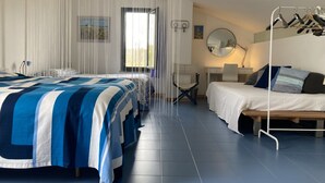 A modern bedroom with a large bed, a smaller bed, a desk, and a chair. - Large modern villa surrounded by olive trees, , 20 minutes to Rome          (Sacrofano)