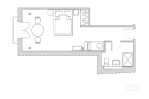 A floor plan of a hotel room with a bed, a desk, a chair, a small table, and a bathroom.