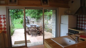 A kitchen with a sliding glass door leading to an outdoor patio area.