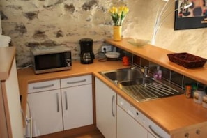 A compact kitchen with white cabinets, a microwave, a coffee maker, and a sink. - Apartment/ flat - COLLIOURE (Collioure)
