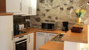 A compact kitchen with white cabinets, a microwave, a toaster, and a small sink. - Apartment/ flat - COLLIOURE (Collioure)