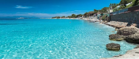 On the beach, sun-loungers