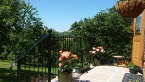 A stone staircase leading to a wooden door, surrounded by potted plants and a metal railing. - Secluded Detached Stable / Barn Conversion On The Border Of Shropshire And Wales (Oswestry Shropshire)