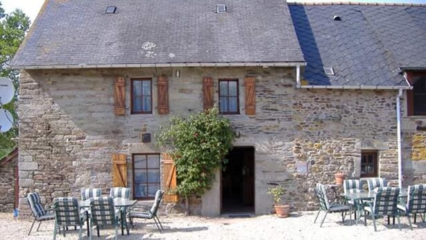 A stone building with a gravel patio and outdoor seating. - Le Cosquer farm (Saint-Connec)