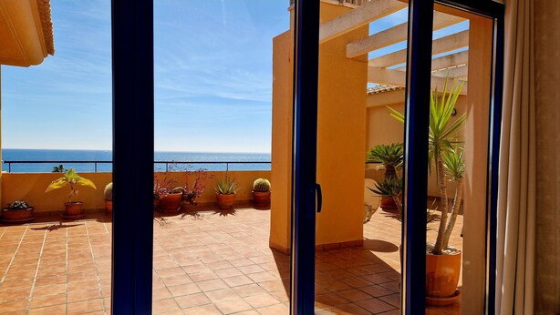 A balcony with potted plants and a view of the sea. - Your vacation home with fantastic south-facing terrace and breathtaking sea view (Manilva)