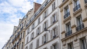 A row of classic European-style buildings with uniform architectural features, including white facades, shutters, and ornate balconies. - Sweett | Troyon - Three Bedroom Apartment, Sleeps 6 (Paris)