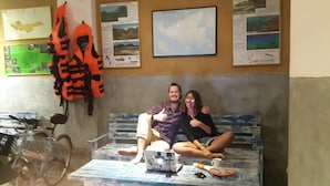 A room with a bench, a bicycle, and a map on the wall. - Cycling Hostel Sri Lanka (Unawatuna)