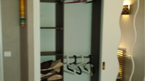 A walk-in closet with shelves and hanging space, a door with a mirror, and a light fixture. - Apartment F3 of 90 M2 near the sea (Cagnes-Sur-Mer)