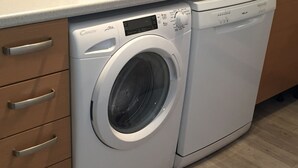 A front-loading white washer and dryer unit with a control panel, a digital display, and a small storage compartment. - 180 ° sea view apartment in Carry le Rouet (Carry-Le-Rouet)