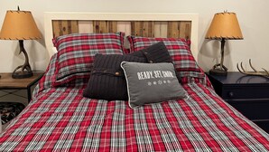 A bed with a red and white plaid bedspread, two lamps on either side, and a pillow with the text "READY, SET, SNOW". - Updated MountainSide Condo in The Heart of Frisco! (frisco)