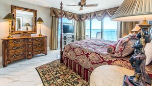 A hotel room with a large bed, a wooden dresser, a television, and a balcony with a view. - 🌴Stunning Panoramic Gulf Views~Boat Slip~Huge Balcony~2BR Waterview Towers 202 (Destin)