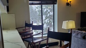 Un espacio de estar acogedor con una mesa de comedor y sillas, un sofá y una televisión.