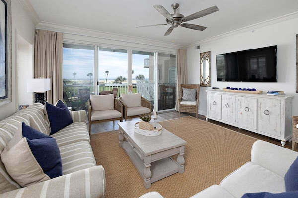 Saint Simons Grand #103 Living Space with Large T.V., Ceiling Fan, Coffee Table, and Patio Access