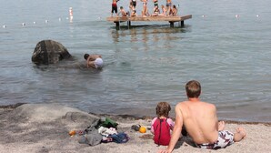 A lake with a dock where people are swimming. - “Bella Vista” Overlooking Beautiful Flathead Lake with Great Panoramic Views! (Somers)