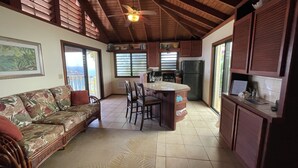 A spacious kitchen with a central island, wooden ceiling, and large windows. - Tropical Orchid-Just For Two-WINTER STORM SALE- Hot Tub (Cruz Bay)