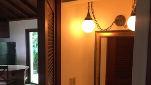 A bathroom with a wooden door, a sink, and a mirror. - Tropical Orchid-Just For Two-WINTER STORM SALE- Hot Tub (Cruz Bay)