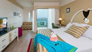 A hotel room with a bed, a TV, a desk, a chair, and a balcony with a view. - Herods Palace Hotels & Spa Eilat (Eilat)