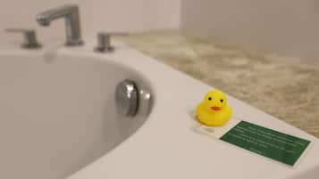 A bathroom sink with a rubber duck and a green sign.