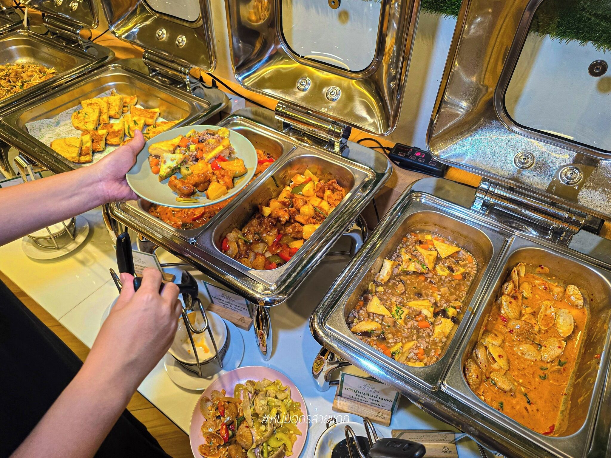 A buffet with various dishes including seafood and mixed vegetables.