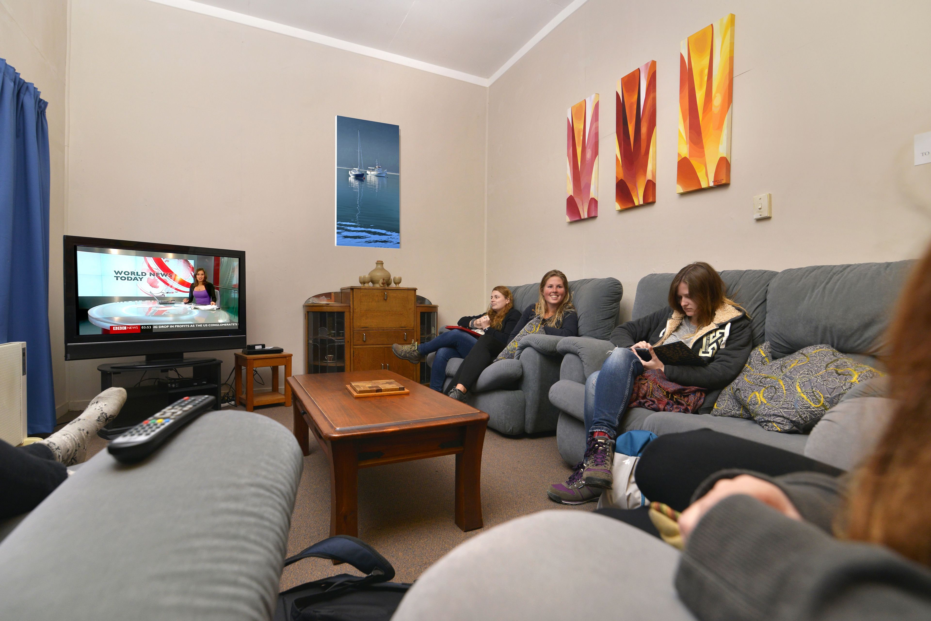 A living room with a television, sofas, and a coffee table.