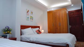 A bedroom with a wooden bed, a wardrobe, and a nightstand with a lamp.