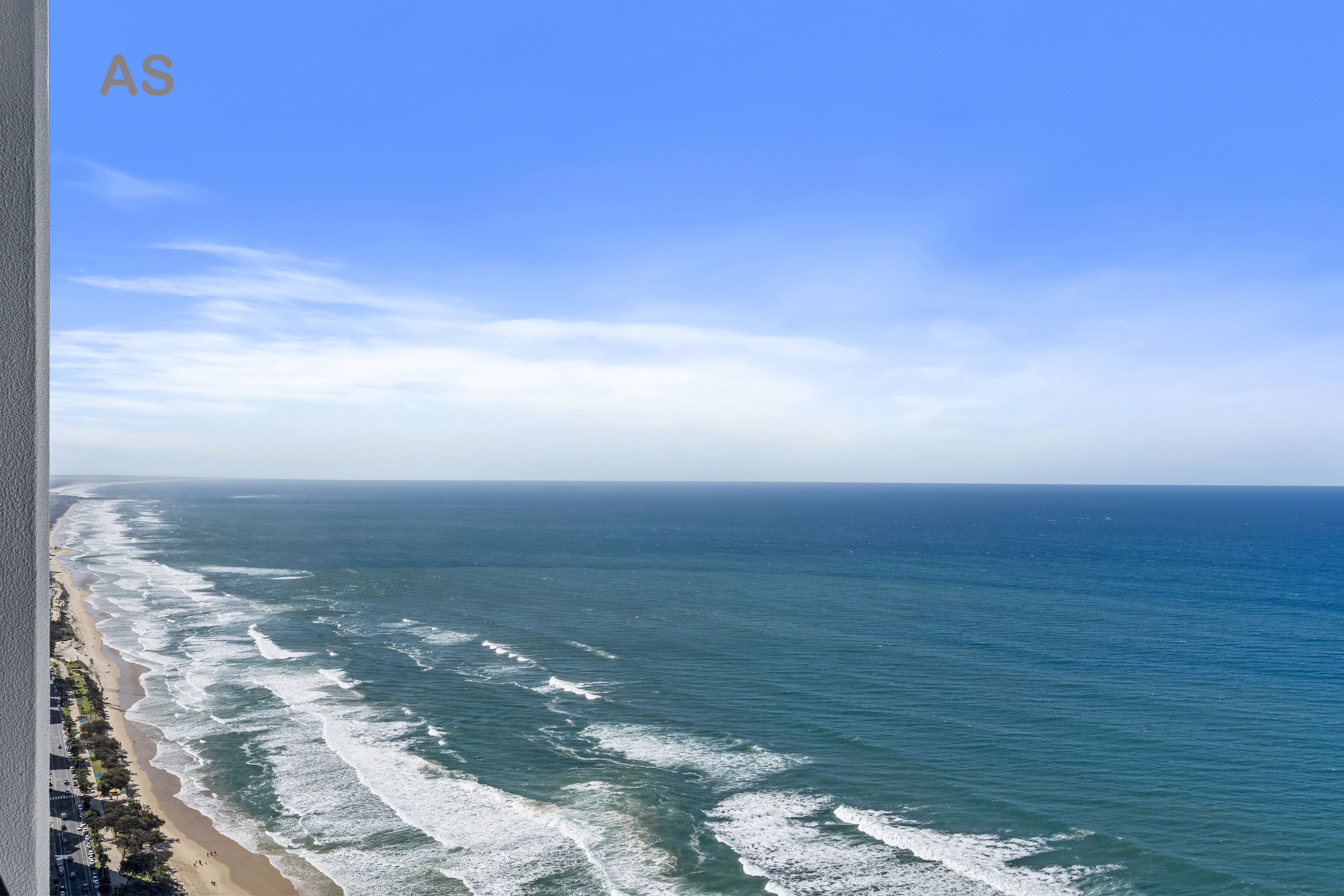 A coastal view with a beach and ocean.