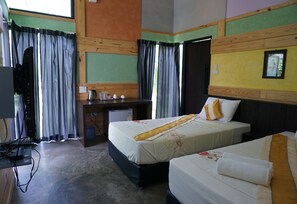 A hotel room with two beds, a desk, a television, and a window with curtains. - The Lampang Villa (Lampang)