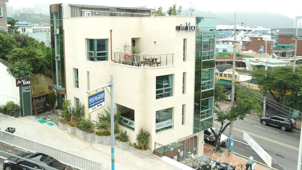 A modern building with a balcony and a sign that reads "for You". - Hostel Foryou (Yeosu)