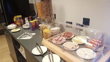 A buffet with various food items and condiments.