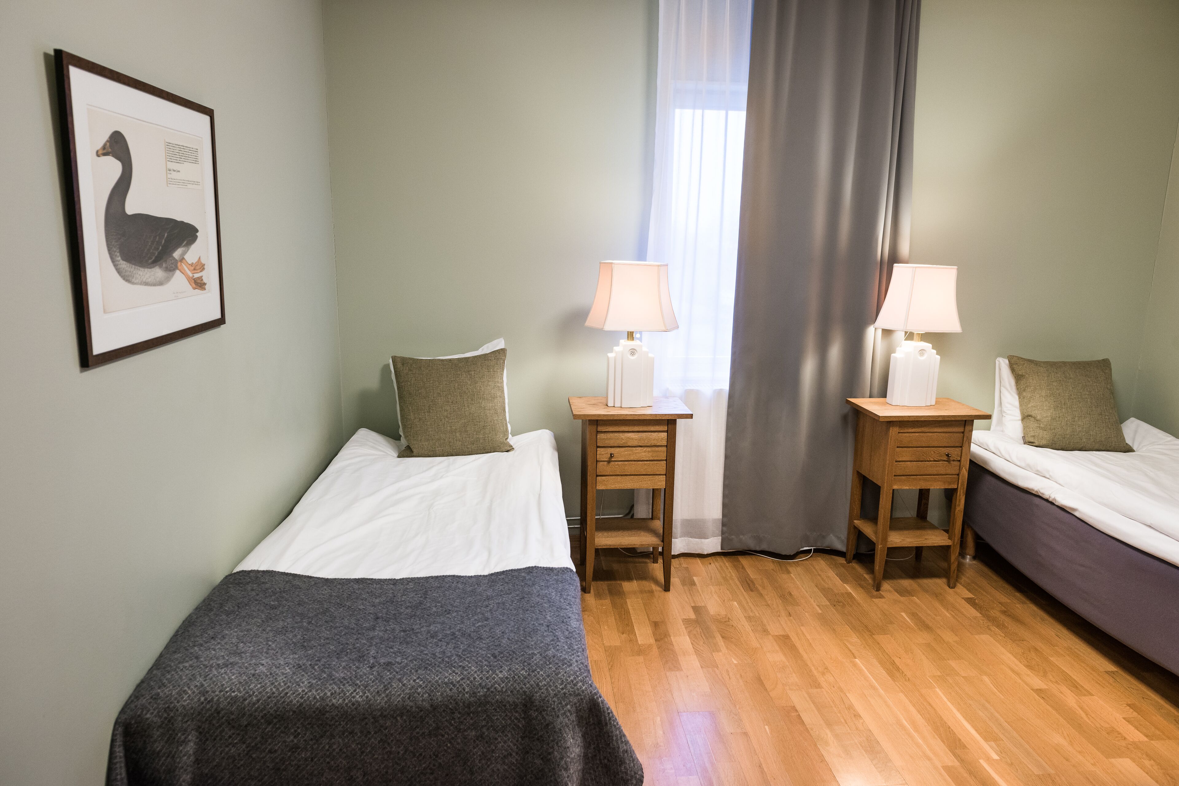 basic twin room | pillow-top beds, desk, laptop workspace, blackout curtains