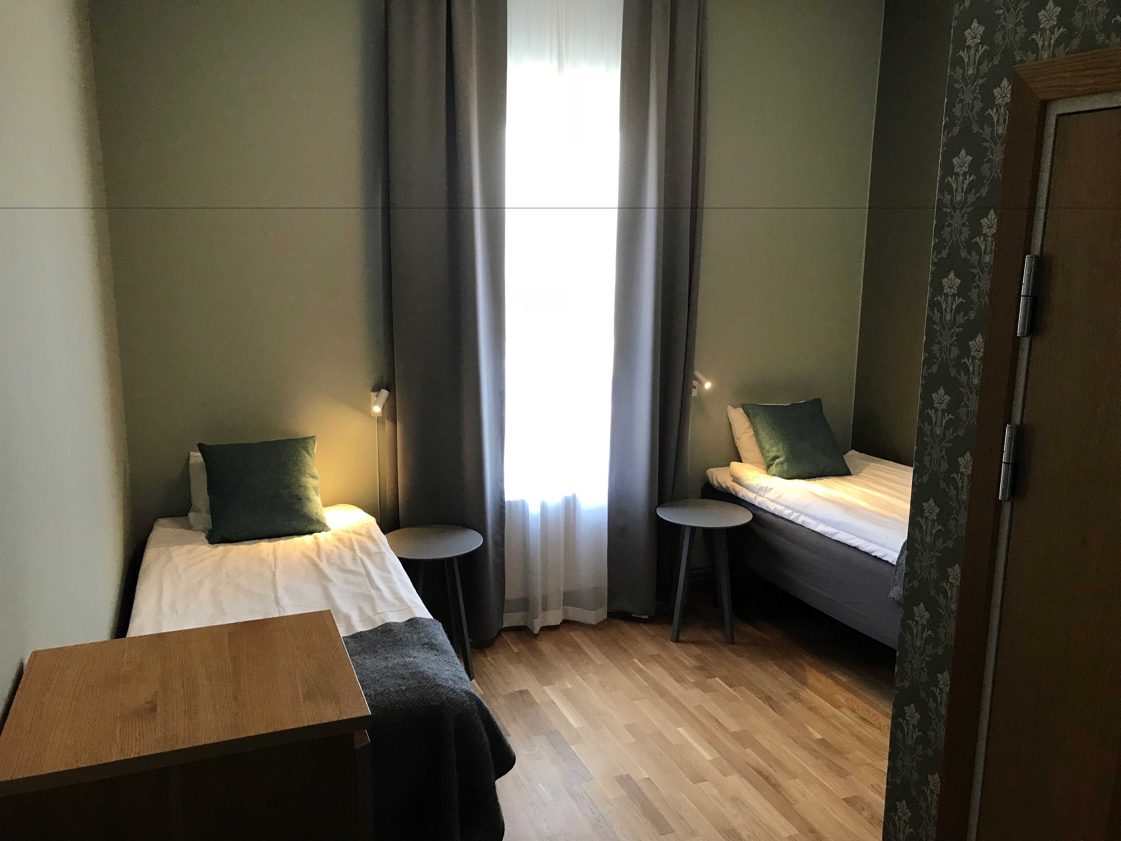 basic twin room | pillow-top beds, desk, laptop workspace, blackout curtains