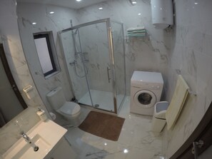 Deluxe Apartment, 2 Bedrooms, Partial Sea View | Bathroom | Shower, free toiletries, hair dryer, bathrobes