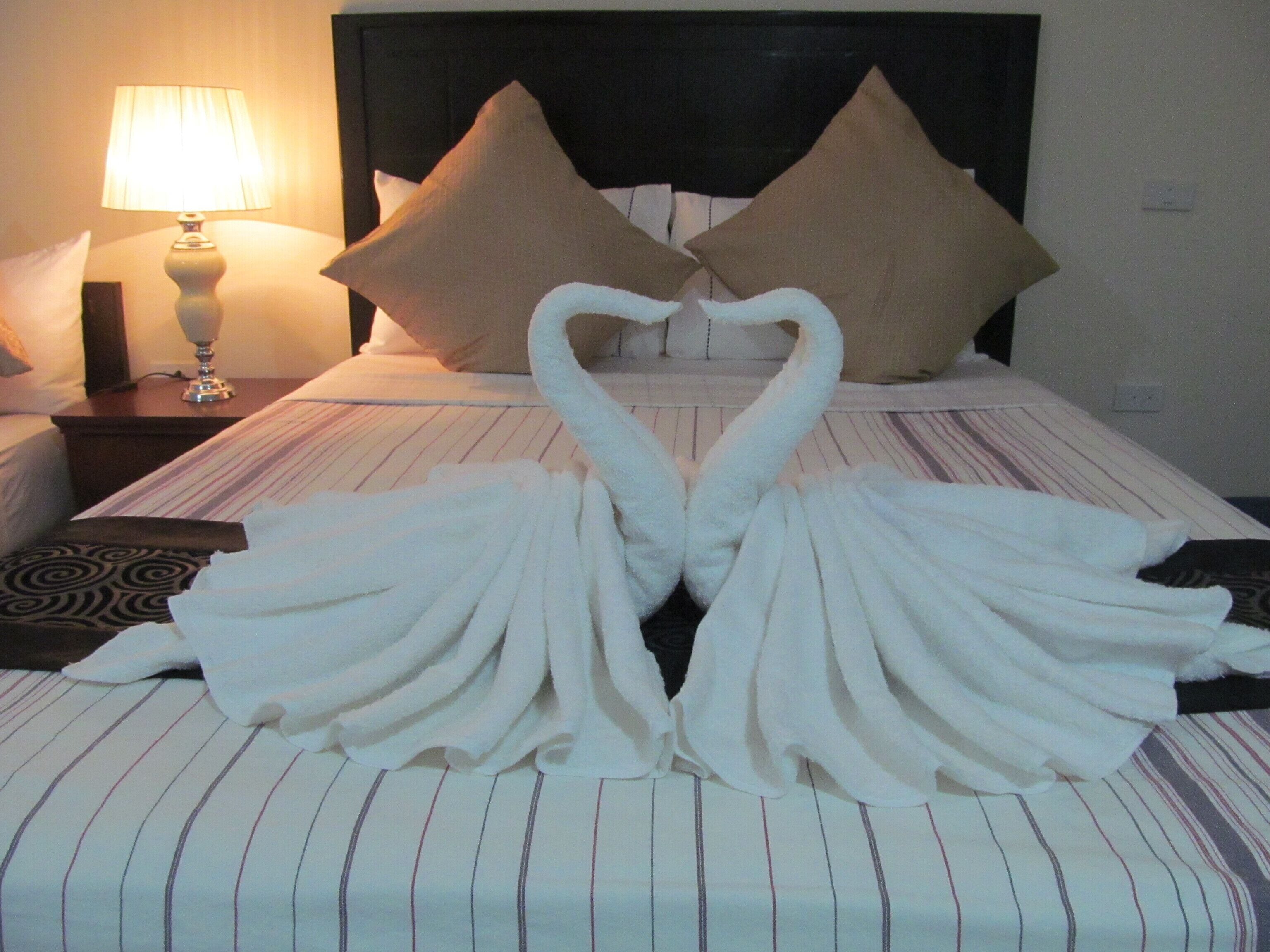 deluxe suite, 1 bedroom, kitchenette, pool view | 1 bedroom, premium bedding, individually decorated