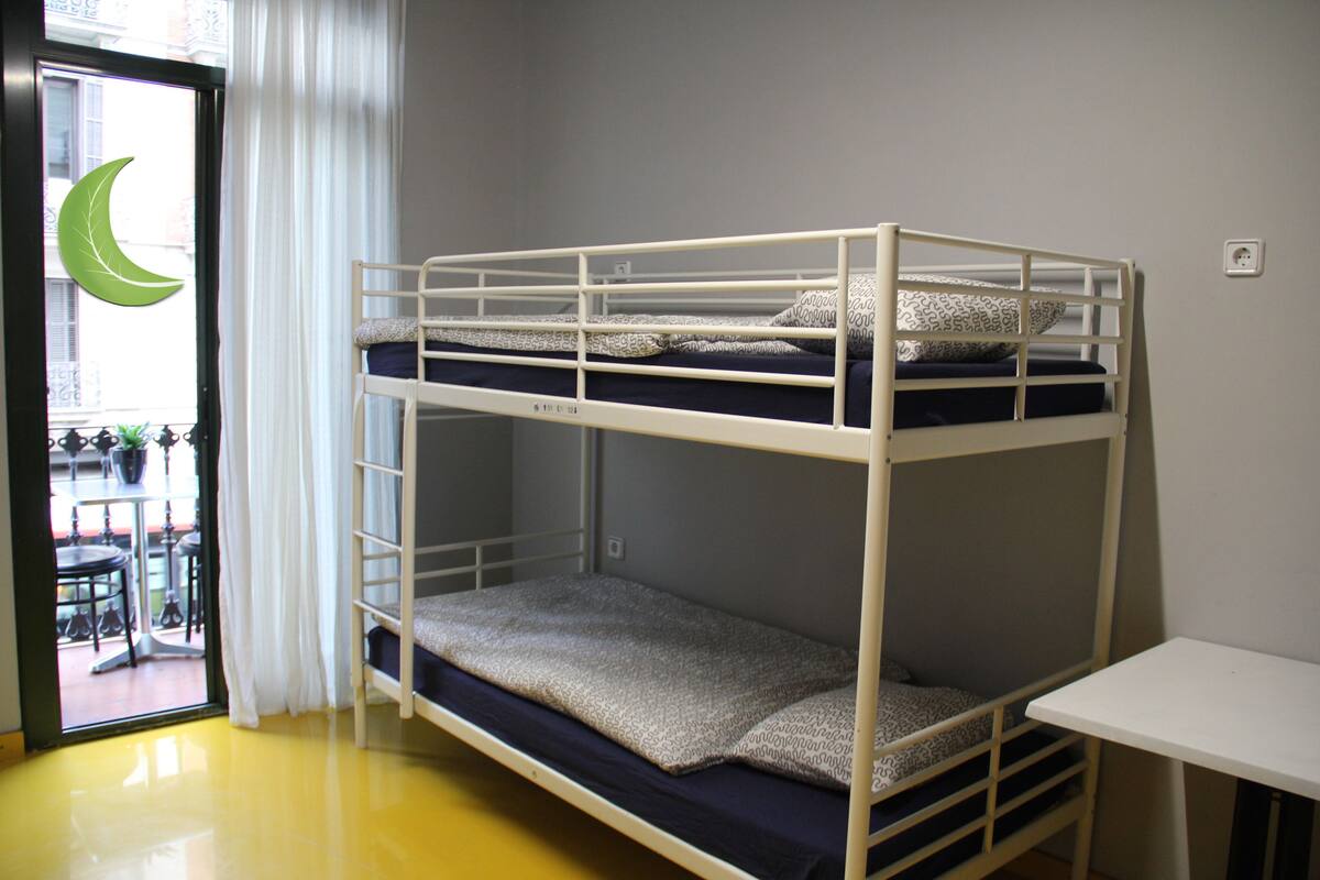 A bunk bed with a lower bunk and a desk.