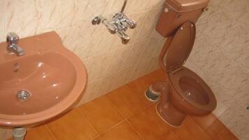 A bathroom with a sink, toilet, and shower.