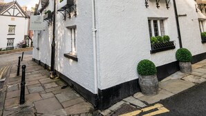 A white building with black trim and a sign that reads "The Bridge." - The Bridge (Macclesfield)