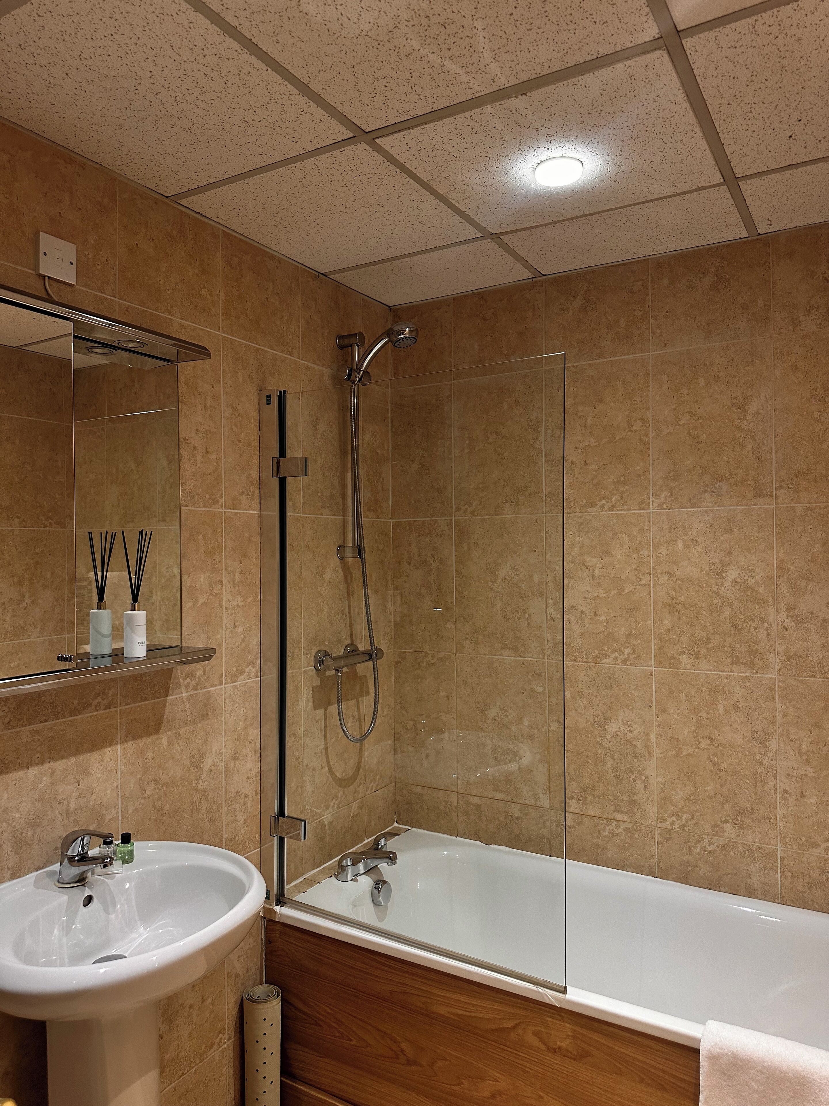A bathroom with a bathtub, a sink, and a shower.