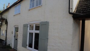 A two-story house with a white exterior and green shutters. - Bell Cottage (Bury St Edmunds)