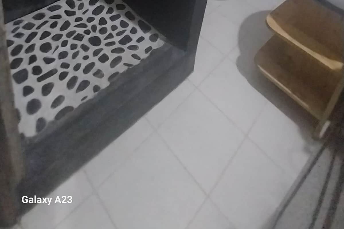 A bathroom with a shower, toilet, and sink.