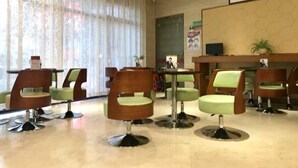 A hotel lobby with modern chairs, a reception desk, and a large window with curtains. - GreenTree Inn Zhongshan Fusha Town Hotel (Zhongshan)