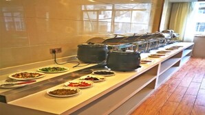 A buffet setup with various dishes and cooking equipment. - Greentree Inn Anhui Anqing Susong North Longmen Rd (Anqing)