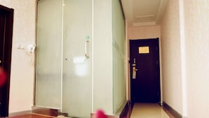 A hallway with a glass door, a telephone, and a door with a sign. - GreenTree Inn Lianyungang Ganyu South Station Express Hotel (Lianyungang)